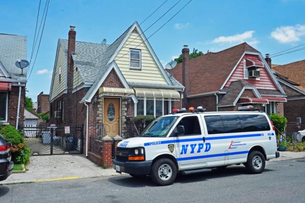 The NYPD stands watch at the Queens house.