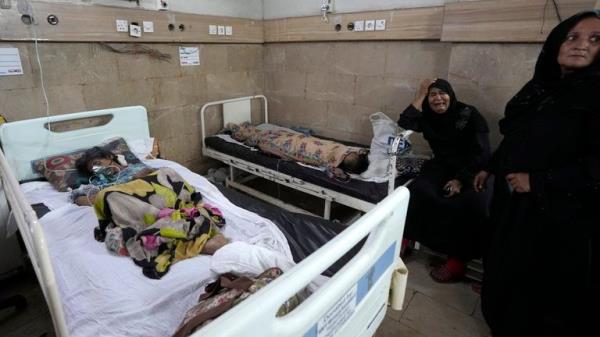 FILE - A woman, center, weeps as patients of heatstroke receive treatment at a hospital in Karachi, Pakistan, June 25, 2024. June 2024 was the hottest June on record, according to Europe's Copernicus climate service on Monday, July 8. (AP Photo/Fareed Khan, File)