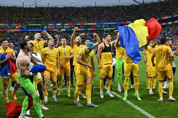 Romania's players celebrate their group win on the pitch after the UEFA Euro 2024 Group E football match between Slovakia and Romania at the Frankfurt Arena in Frankfurt am Main. Photo by Javier Soriano/AFP