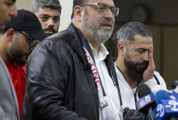 Oday al-Fayoume, right, the father of Wadea al-Fayoume, rubs his face while Wadea’s uncle, Yousef Hannon, speaks at the Muslim Community Center on Oct. 15, 2023, a<em></em>bout the stabbing death of 6-year-old Wadea.