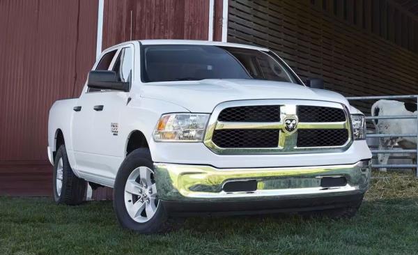 a white truck parked in front of a barn