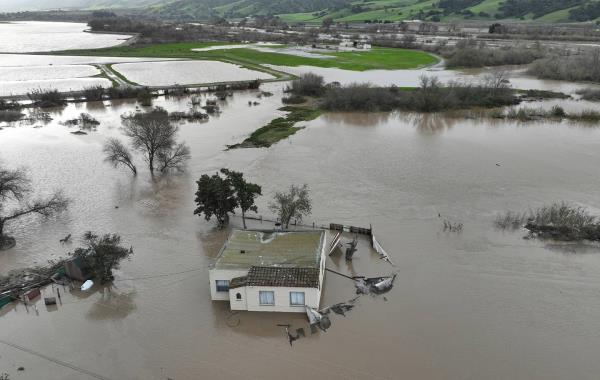 In an aerial view, a home is seen submerged in floodwater as the Salinas River begins to overflow its banks on January 13, 2023 in Salinas, California. 