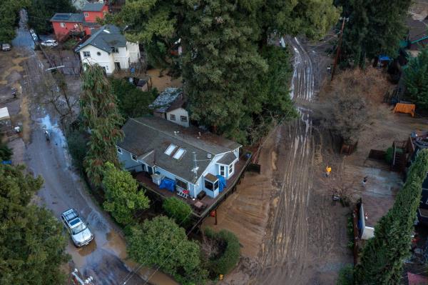 In this aerial picture taken on January 14, 2023, residents clean up their muddy neighborhood in Felton, California, as a series of atmospheric river storms co<em></em>ntinues to cause widespread destruction across the state. 