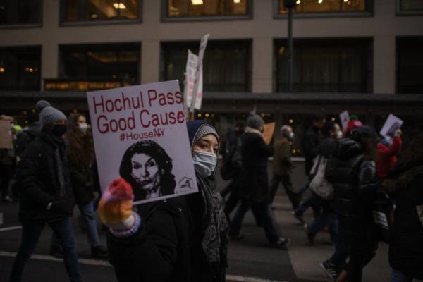 Protesters hold placards and shout slogans during a march calling for an extension to the eviction moratorium in 2022.