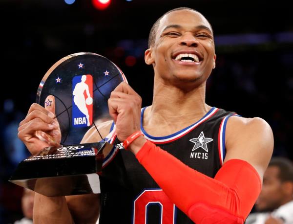 Russell Westbrook, of the Oklahoma City Thunder, holds the MVP trophy after the NBA All-Star basketball game, Sunday, Feb. 15, 2015.