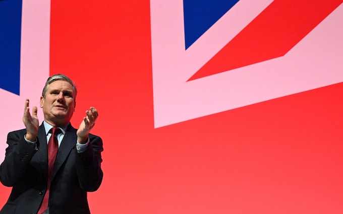 Britain's main opposition Labour Party leader Keir Starmer applauds a speaker the final day of the annual Labour Party conference