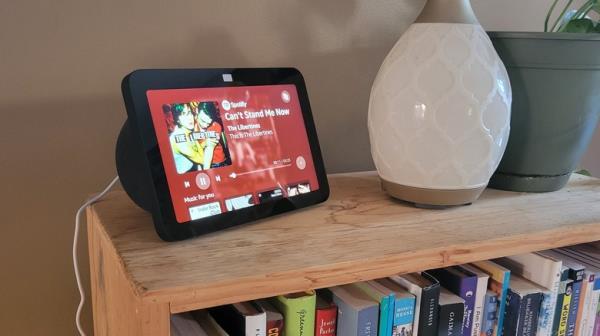 Echo Show 8 on bookshelf playing music