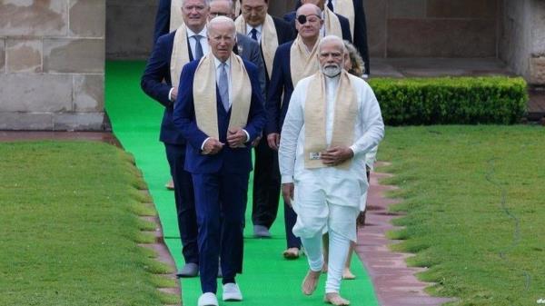 A handout photo made available by the Indian Press Information Bureau (PIB) shows Indian Prime Minister Narendra Modi (front R) walking with US President Joe Biden (front L) and other world leaders upon arrival at the Mahatma Gandhi