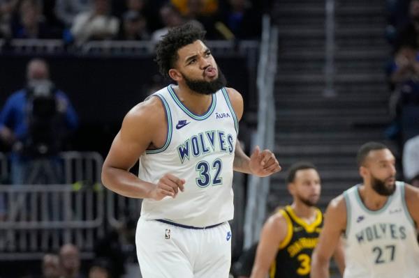 The Timberwolves' Karl-Anthony Towns reacts after scoring against the Warriors on Nov. 12, 2023.