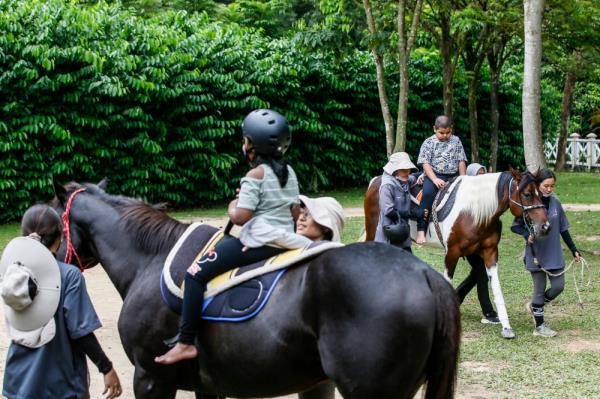 Special needs children attending hippotherapy sessions in the Horse Unit Complex at Green Apple Hippotherapy in Putrajaya, December 10, 2023. — Picture by Hari Anggara