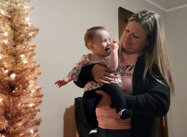 Arlette Martin, right, decorates a tree with her 6-month-old great-niece, Lochlyn Grace Smith, in LaSalle, Illinois. Martin, of Peru, Illinois, has been estranged from her daughter since 2019.