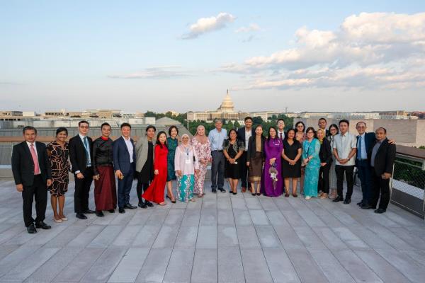 A group of people pose stand in a line to pose of a group photo