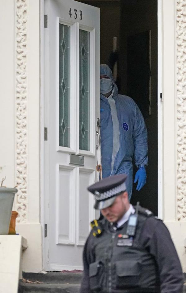 Police officers at the scene of a property in Dalston, east London