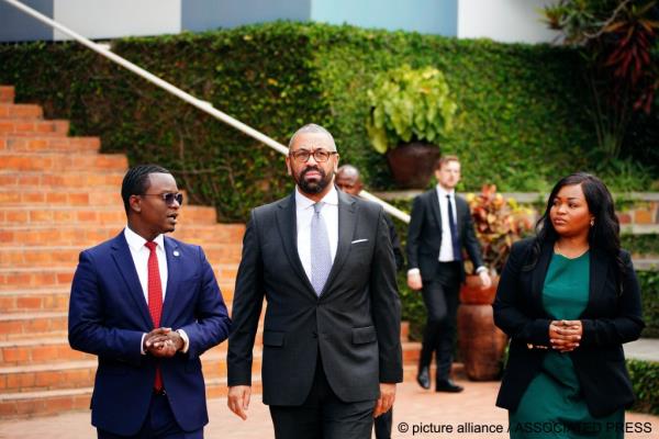 Britain‘s Home Secretary James Cleverly, centre, visits the Kigali Genocide Memorial in Kigali, Rwanda, Tuesday, Dec. 5, 2023, on the day he signed a new treaty with the country | Photo: Ben Birchall/PA Wire via AP