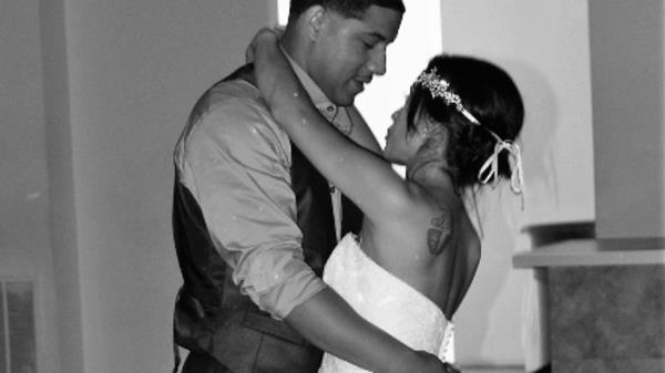 Christopher Fitzgerald dances with his wife at their wedding