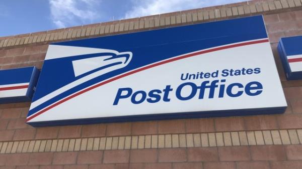 A close up of a U.S. Post Office sign