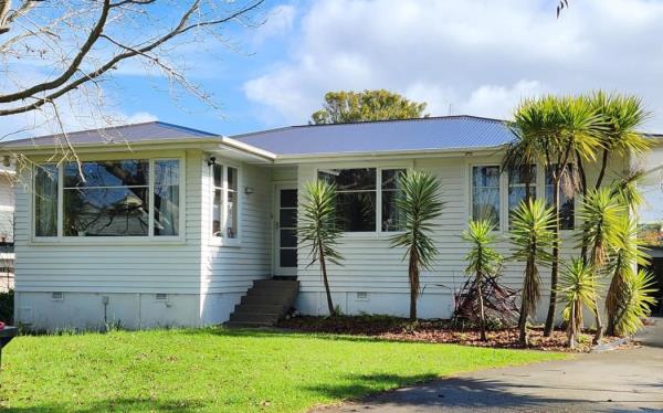 A picture of a white coloured one-storey home.