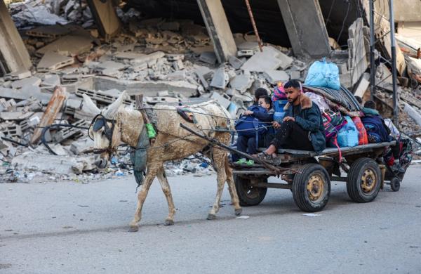 Residents of the refugee camp of Bureij arrive in Deir al-Balah in the central Gaza Strip following an evacuation order on Friday.