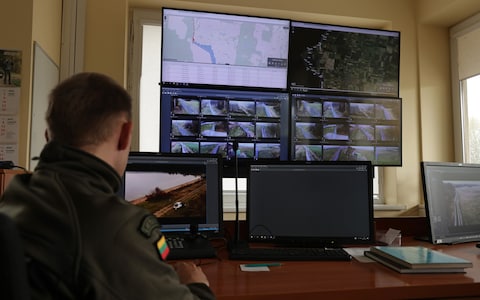 A Lithuanian border guard mo<em></em>nitors the video feed from cameras along the border to the Russian semi-exclave of Kaliningrad in Vistytis, Lithuania