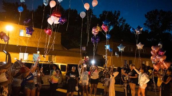 Family and friends release balloons at a private vigil. Pic; AP