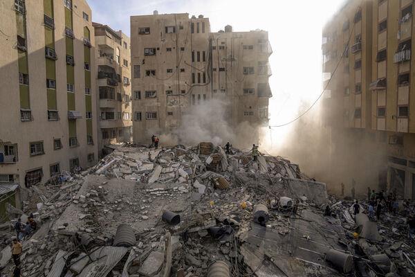 Palestinians inspect the rubble of a building after it was struck by an Israeli airstrike in Gaza City last Saturday. Photo: AP/Fatima Shbair