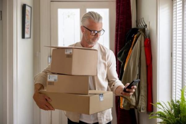 Packages being delivered to a home, as seen from a security camera.