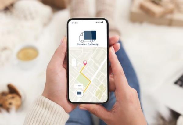 Modern courier delivery at home, shopogolic and o<em></em>nline shopping. Hands of lady holding smartphone with mobile app and map to track the order on digital screen on blurred background, collage, cropped