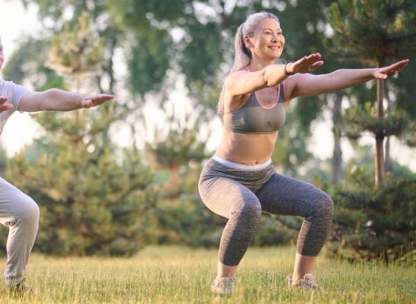 woman doing bodyweight squats, co<em></em>ncept of exercises for quicker weight loss