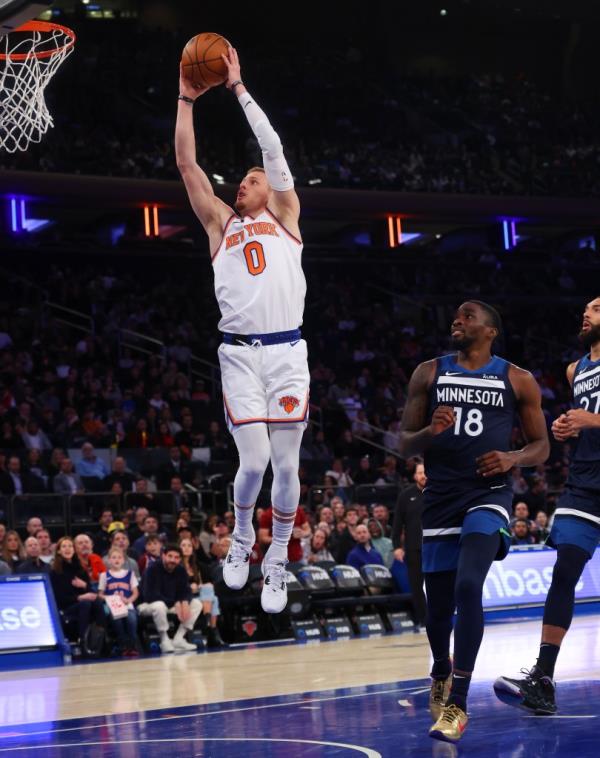 Knicks guard Do<em></em>nte DiVincenzo (0) slams the ball in front of Minnesota Timberwolves guard Shake Milton (18).