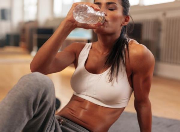 woman drinking water workout