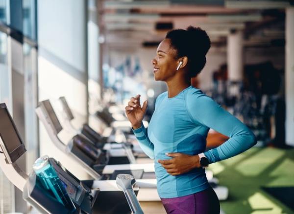 fit woman running on treadmill, co<em></em>ncept of exercise and nutrition tips for women in their 40s