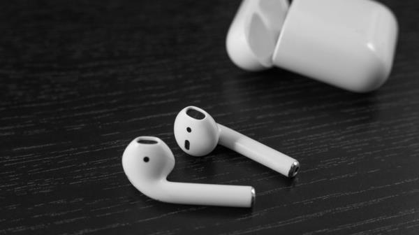 Apple AirPods on black table