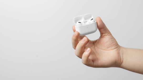 hand holding AirPods case open