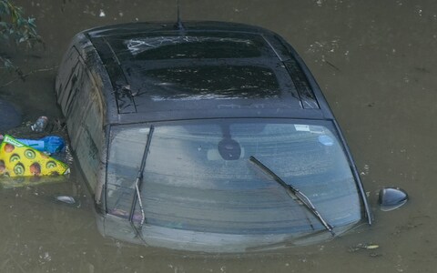 A car is abando<em></em>ned in flood water in the village of Catcliffe near Sheffield