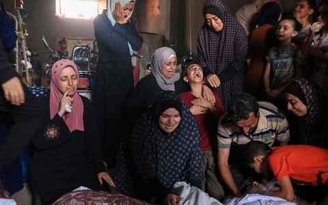 Palestinians mourn during the funeral of members of the Qudaih and Alshrafi families killed in overnight strikes on the southern Gaza Strip, in Khan Yunis on November 13, 2023, amid o<em></em>ngoing battles between Israel and the Palestinian Hamas movement.