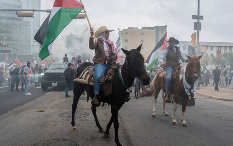 Mounted pro-Palestinian demo<em></em>nstrators lead the march down San Jacinto Boulevard and through downtown Austin, Texas, following the 