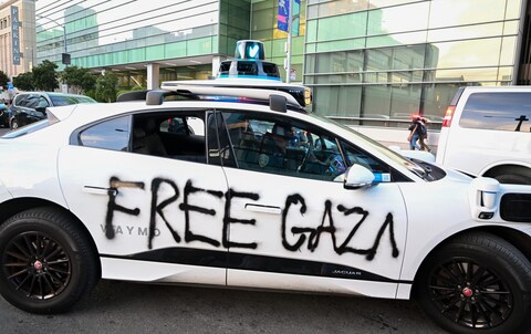 A Waymo self-driving car that was vandalized is seen as Pro-Palestine protestors and protesters of Asia-Pacific Eco<em></em>nomic Cooperation (APEC) global trade summit gather near the Ferry Building and march toward the Moscone Center in San Francisco, California, United States on November 12, 2023.