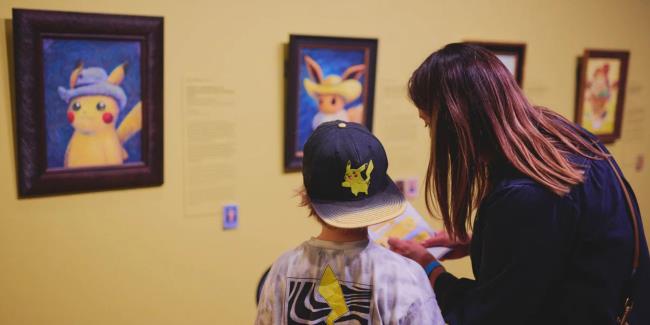 parent and child looking at pokemon van gogh artwork