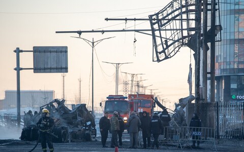 Firefighters and police work at the scene of an explosion from a vehicle crash in Ulaanbaatar, the capital of Mongolia