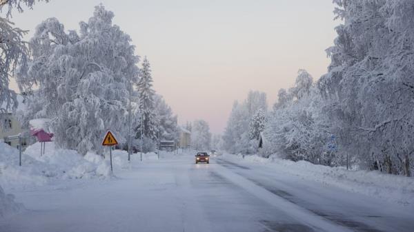 Snow and frost cover a road in Vittangi in northern Sweden