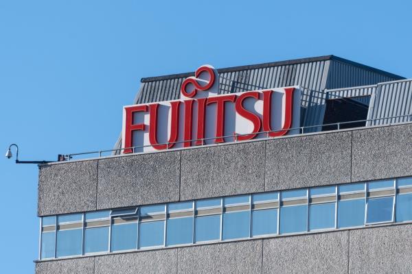 A Fujitsu sign on the top of a building. 