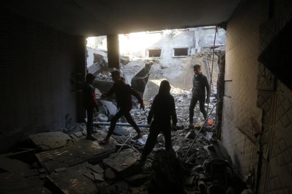 Palestinians survey the destruction after an Israeli strike in Rafah on Dec 24.