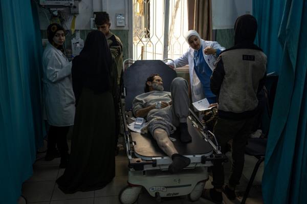 Palestinians who were arrested by the Israeli military in the north of the Gaza Strip and released through the Kerem Shalom crossing in the south wait for treatment in Rafah on Sunday, Dec. 24, 2023.