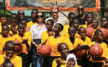 Prince Harry and Meghan pose for photos at a basketball event