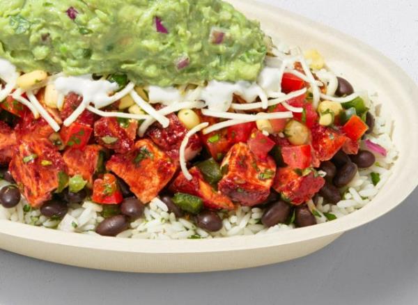 burrito bowl featuring chipotle's chicken al pastor, rice, beans, tomato salsa, corn salsa, cheese, sour cream, and guac