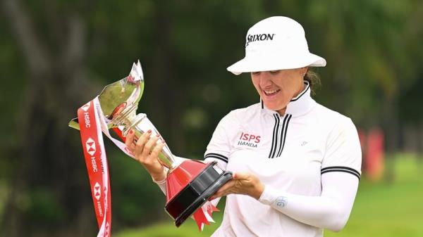 Hannah Green inspects her trophy at the HSBC Women's World Championship