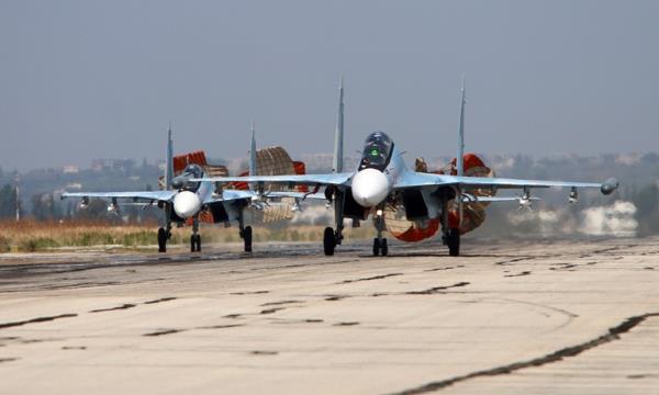 A picture taken on October 3, 2015 shows Russian Sukhoi Su-30 SM jet fighters landing on a runway at the Hmeimim airba<em></em>se in the Syrian province of Latakia. AFP PHOTO / KOMSOMOLSKAYA PRAVDA / ALEXANDER KOTS *RUSSIA OUT* (Photo by ALEXANDER KOTS / KOMSOMOLSKAYA PRAVDA / AFP) / RUSSIA OUT