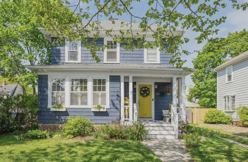 Two story blue home with porch