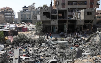 Residents walk among debris following Israeli strikes on the area in Gaza wher<em></em>e hostages were rescued on Saturday