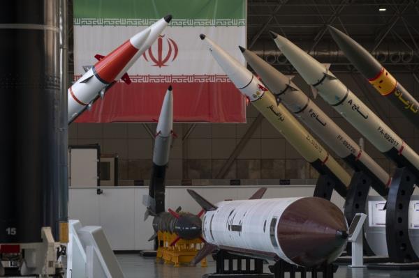 Iranian surface-to-surface missiles are pictured next to an Iran flag at the Islamic Revolutio<em></em>nary Guard Corps (IRGC) Natio<em></em>nal Aerospace Park in western Tehran, on Oct. 11, 2023. 